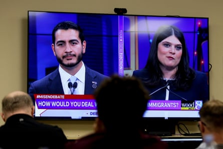 A man and a woman shown on television face off in a debate