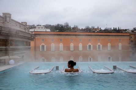 A woman in a rooftop thermal pool