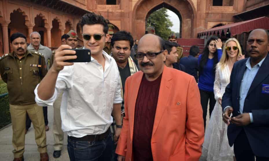 Orlando Bloom, front left, takes a selfie with Indian politician Amar Singh, at the Taj Mahal in Agra.