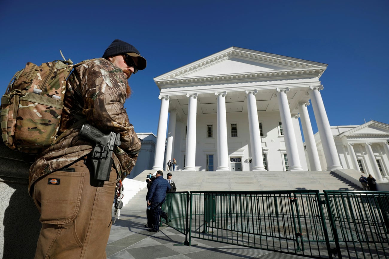 A gun rights activist carries his handgun in a hip holster outside the Virginia state capitol building as the general assembly prepares to convene in Richmond, on 8 January.