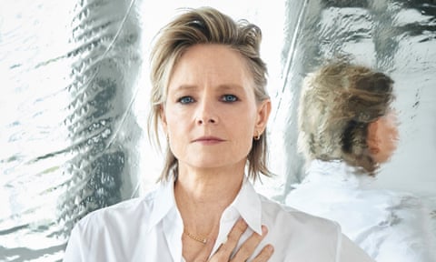 Portrait of Jodie Foster in crisp white shirt against a shiny background