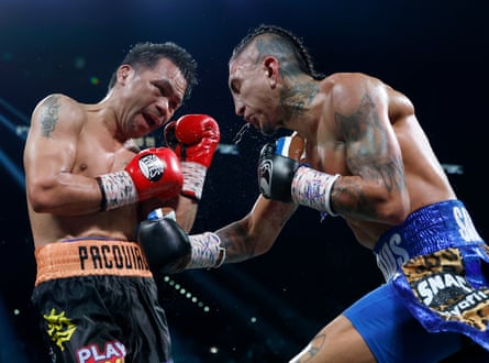Mario Barrios, right, lands a shot to Manny Pacquiao’s body on Saturday night.