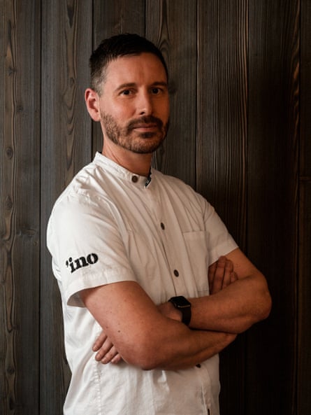 a man stands with his arms crossed