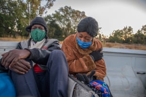 Sandra Chikore sits in the back of a pick-up truck