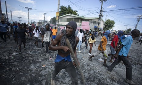 A protester carries a piece of wood simulating a weapon during a protest against the prime minister, Ariel Henry, in the Petion-Ville, Port-au-Prince, this week.