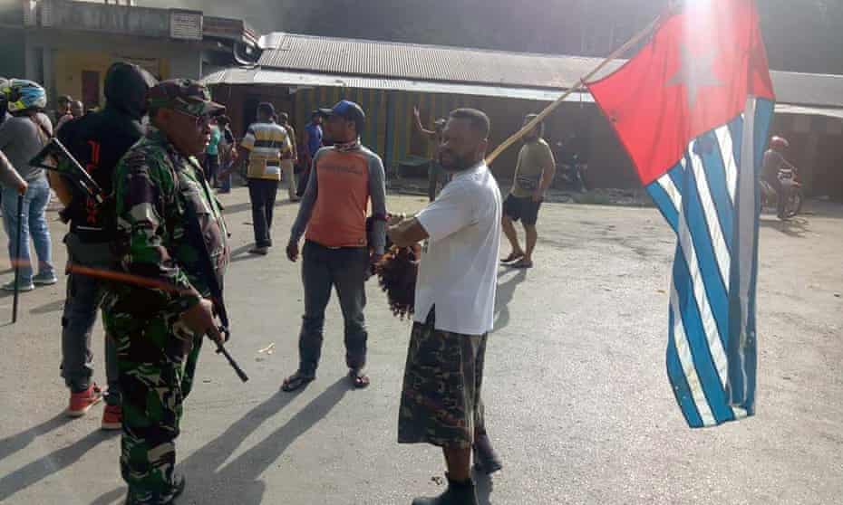 A protester in Fakfak carries the banned Papuan flag