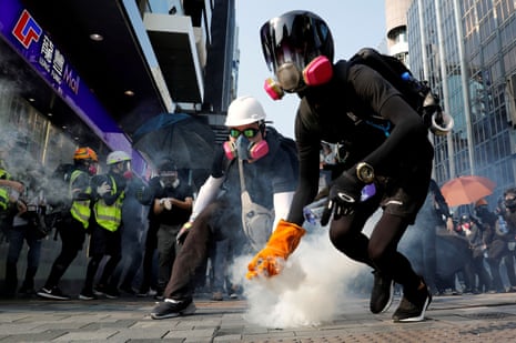 An anti-government protester holds a teargas canister during a protest in Hong Kong.