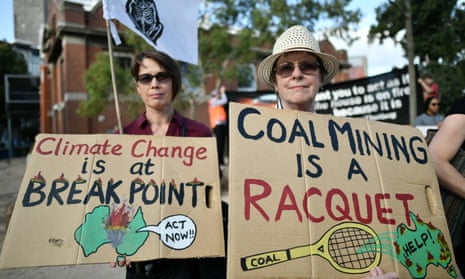 Demonstrators hold up placards outside the Australian Open venue during a climate protest rally in Melbourne on January 24, 2020.