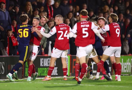 Max Dowman is surrounded by Fleetwood players after his red-card offence