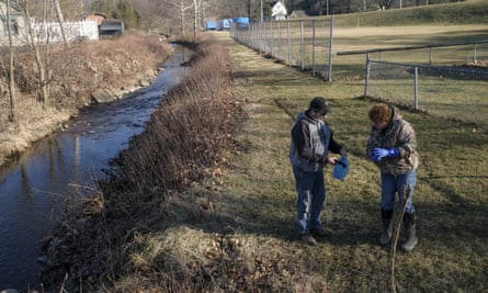 Residents from Norton, Ohio, take water samples from Leslie Run creek for private testing in East Palestine, Ohio.
