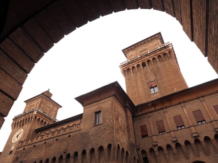 The castle towers pictured from under an arch of the nearby municipal theatre