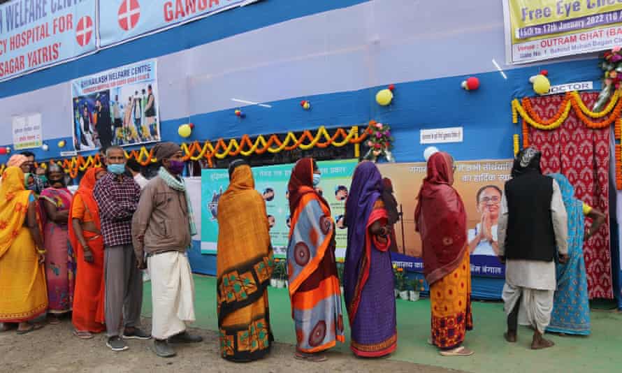 People wait for a health checkup at Gangasagar transit camp in Kolkata , India.