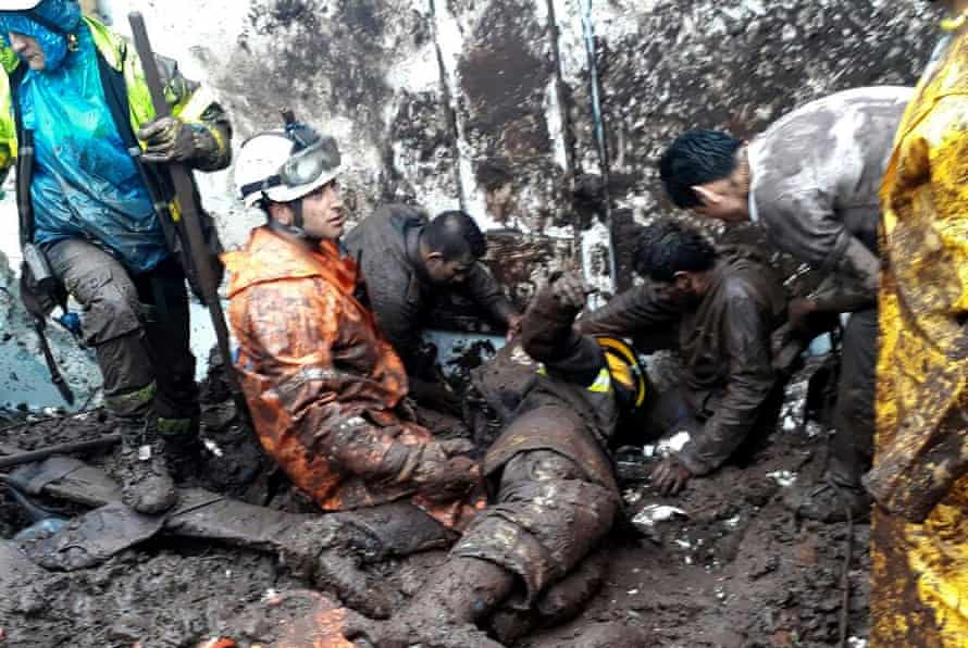 Rescuers work at the site of a landslide in Manizales in 2017