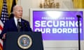 man wearing suit stands at podium in front of microphone with 'President Joe Biden Securing Our Border' on the screen behind him