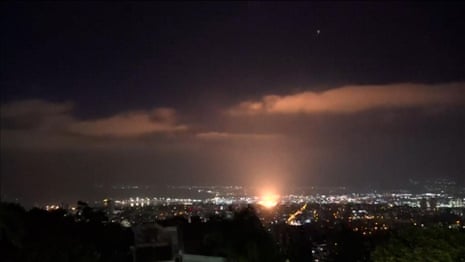 Moment apparent projectile hits Haifa in Israel on third night of conflict with Iran – video