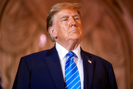 a man in a blue suit and blue tie looks ahead