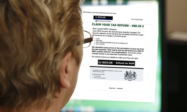 A woman reads a phishing email claiming she is entitled to a tax refund.