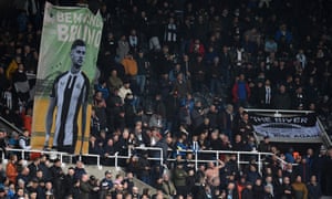 Newcastle fans unveil a large banner of Newcastle United's Brazilian midfielder Bruno Guimaraes in the crowd.