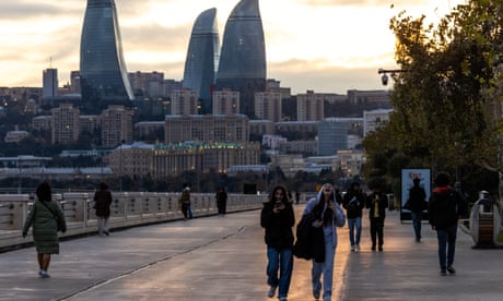Drylands now make up 40% of land on Earth, excluding Antarctica, study says 2 People walk on the embankment with the Flame Towers in the background a