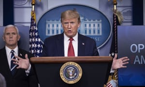 Donald Trump speaks during a coronavirus briefing while Mike Pence listens at the White House on 16 April.