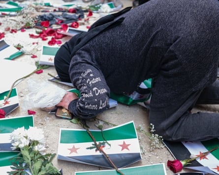 A woman kneels down to the floor.