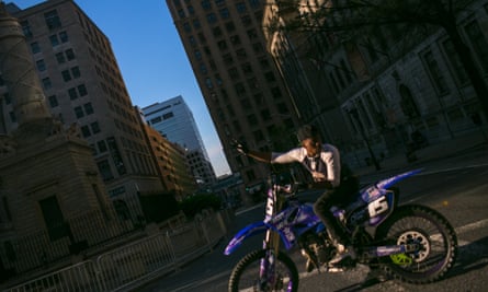 A rider manages traffic on a Sunday in Baltimore. Different riders take turns holding traffic for the rest of the pack
