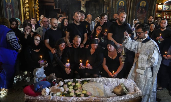 Relatives and friends pay their last respects to Liza, a 4-year-old girl killed by a Russian attack, during a mourning ceremony in an Orthodox church in Vinnytsia, Ukraine, Sunday, July 17, 2022. Wearing a blue denim jacket with flowers, Liza was among 23 people killed, including 2 boys aged 7 and 8, in Thursday’s missile strike in Vinnytsia. Her mother, Iryna Dmytrieva, was among the scores injured.
