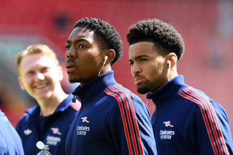 Myles Lewis-Skelly of Arsenal looks on with teammate Ethan Nwaneri at Anfield