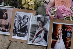 Flowers are placed next to pictures of the Queen outside the British Consulate General in Hong Kong