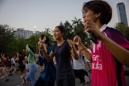 Panisa Taratchon, 20, and Nawatakorn Suwanprapa, 24, dancing in the crowd