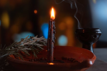 Traditional ritual with fire and black candle in clay plate accompanied by pepper, sea salt, herbs and incense