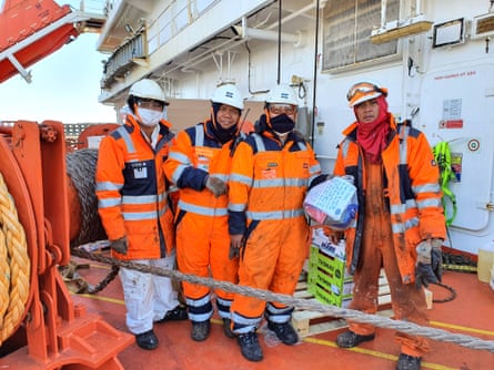 Four Filipino seafarers onboard a ship in port at Rotterdam holding gift bags
