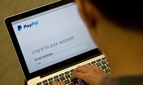 A person uses PayPal on a laptop