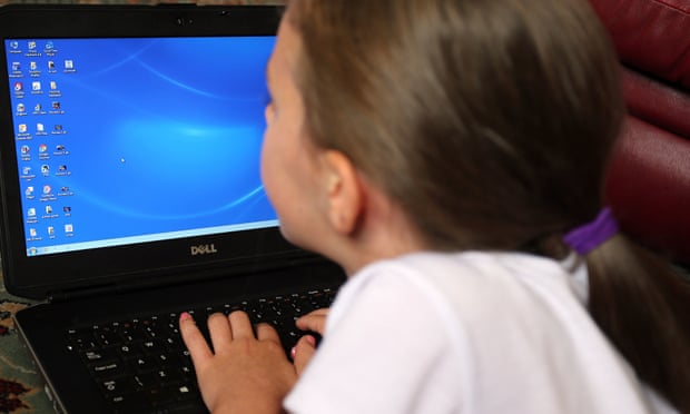 Young girl using a laptop for school