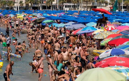 People cool off at the beach in Benidorm, Spain.