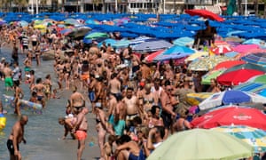 People cool off at the beach in Benidorm, Spain.