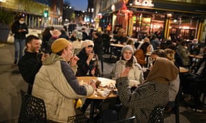 Customers enjoy drinks at tables outside the bars in the Northern Quarter of central Manchester, on April 12, 2021 as coronavirus restrictions are eased across the country in step two of the government’s roadmap out of England’s third national lockdown.