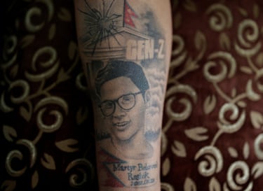 A tattoo of Rashik Khatiwada’s face on the arm of his mother