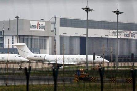 A white jet at an airport