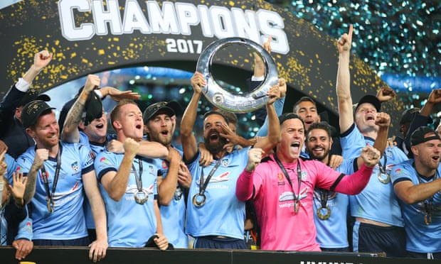 Alex Brosque holds aloft the winners' trophy and celebrates with teammates after winning the A-League grand final at Allianz Stadium. Photograph: David Moir/AAP  