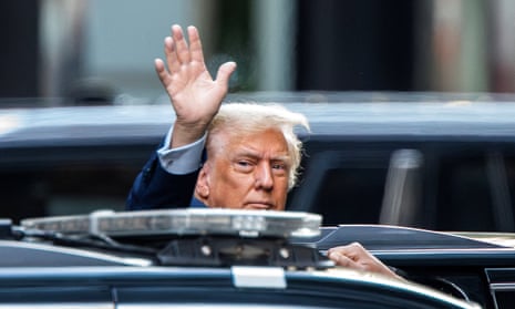 Donald Trump waves to supporters as he exits Trump Tower this morning.