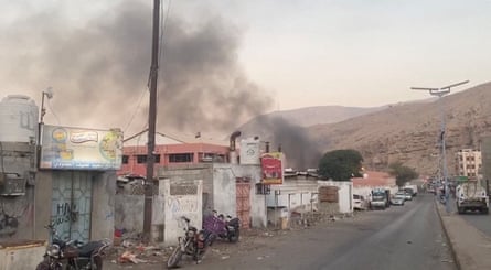 Smoke rises over buildings