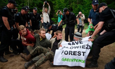 Polish police remove Greenpeace activists blocking logging machines in Białowieża forest, Czerlonka, Poland. 