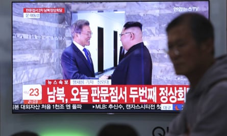 A TV screen shows Moon Jae-in and Kim Jong-un.