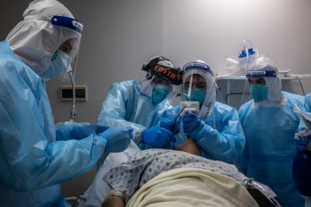 Healthcare workers treat a patient suffering from Covid-19 in Houston, Texas.