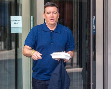 Andy Burnham in a blue polo shirt and jeans