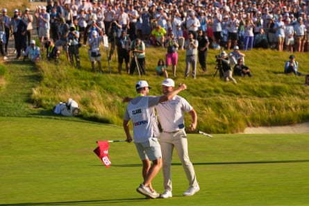 Wyndham Clark celebrates with his caddie David Pelekoudas after winning the US Open