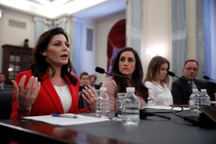 Gymnast Jamie Dantzscher gestures while speaking at a microphone during a Senate hearing in April 2018.