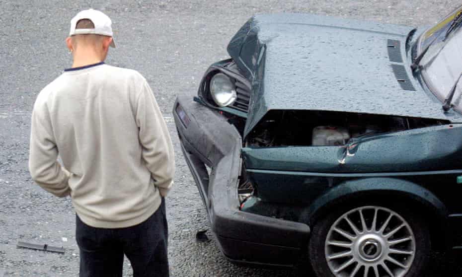 A young man looking at damage to his VW Golf GTI