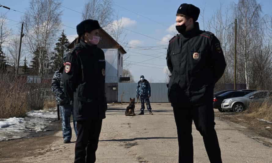Russian police officers guard the entrance to the penal colony where Alexei Navalny is being held, ahead of a planned protest in his support on Tuesday.